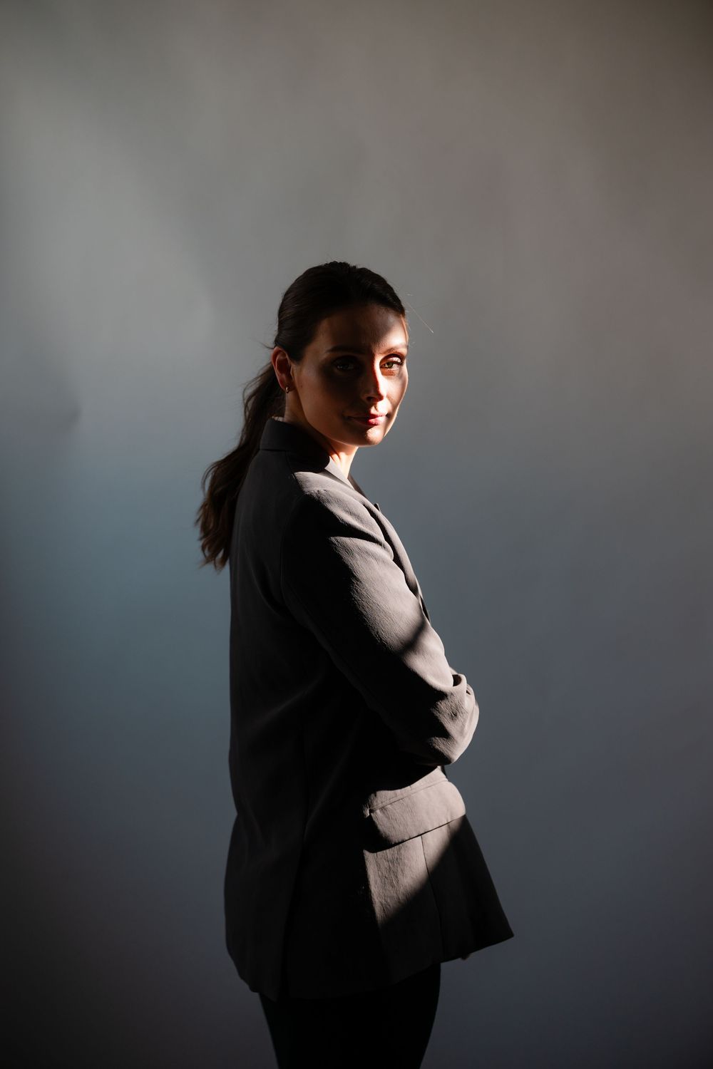 A series of dramatic silhouette grand rapids based portraits showing a figure in a suit against a dark background with moody lighting.