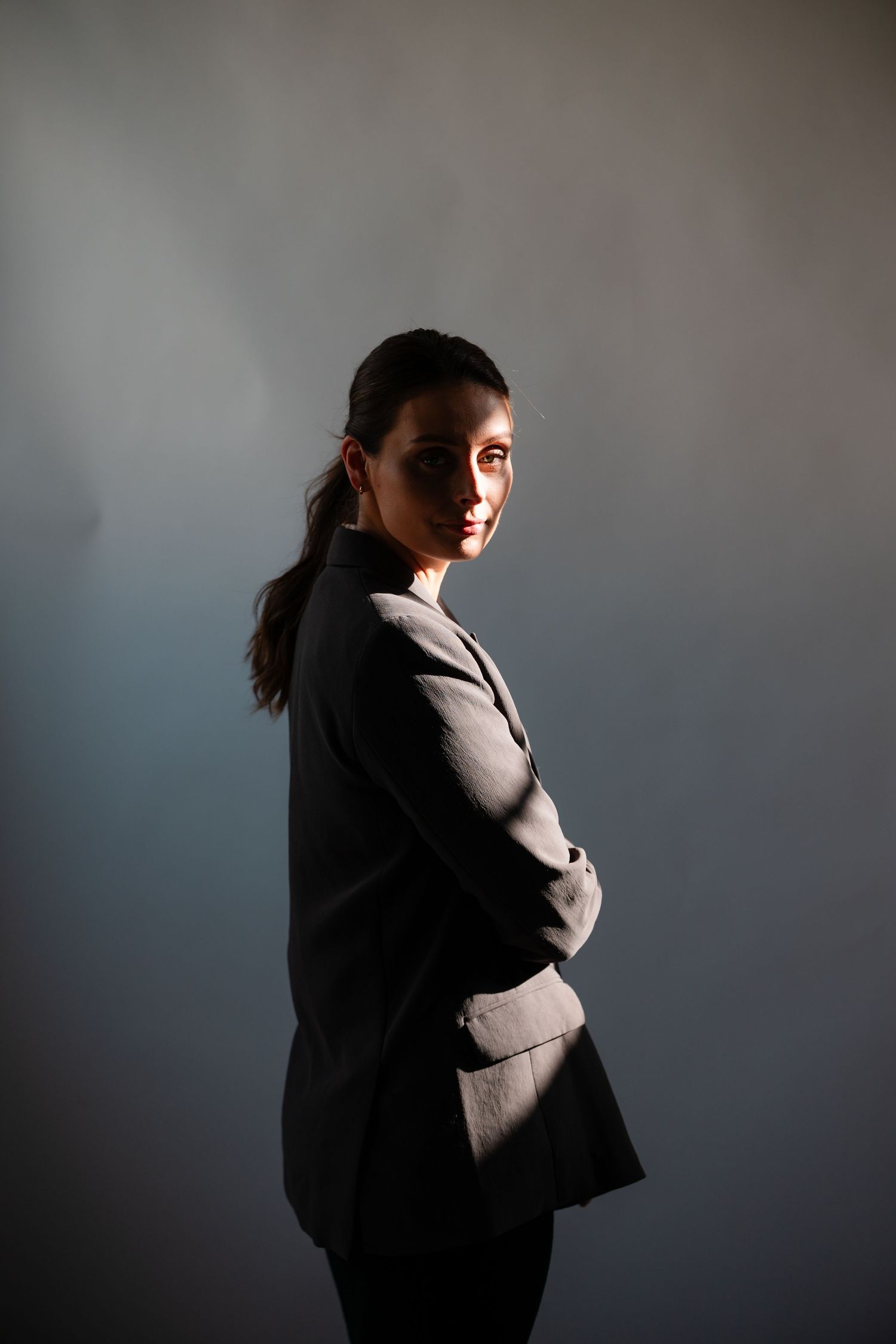 A series of dramatic silhouette grand rapids based portraits showing a figure in a suit against a dark background with moody lighting.