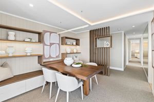 Modern basement renovation features wood accents, recessed lighting, and clean white walls in an open concept design.