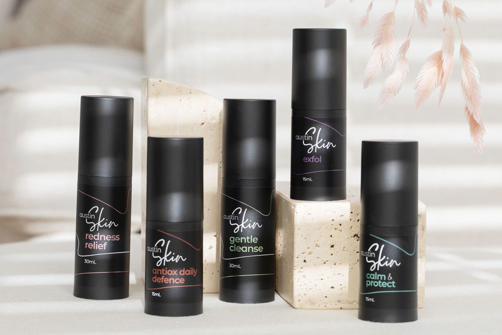 Black cosmetic deodorant containers arranged in a row against a light background showing product packaging design.