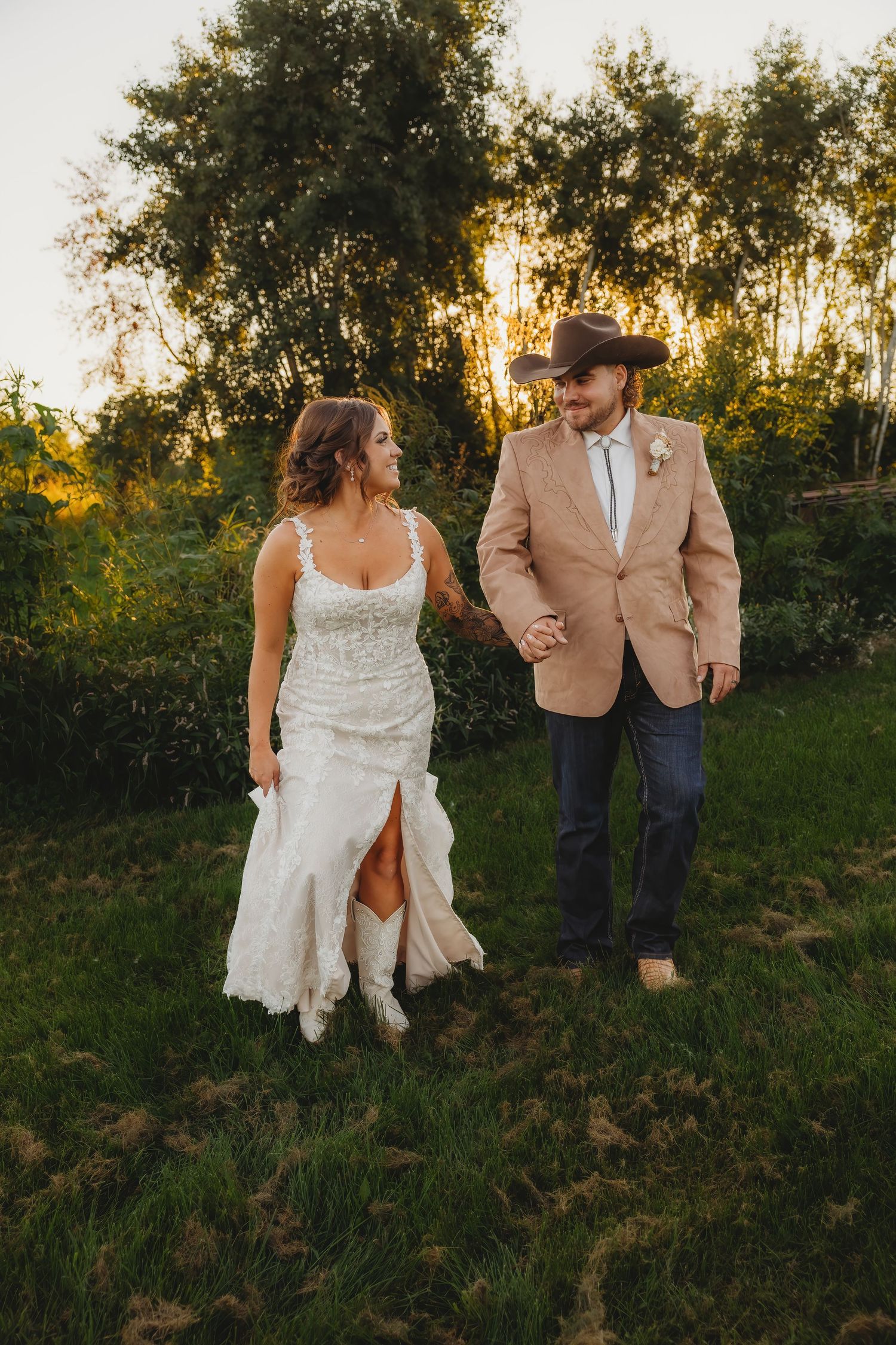 Couple poses for wedding photos in front of red fire truck.