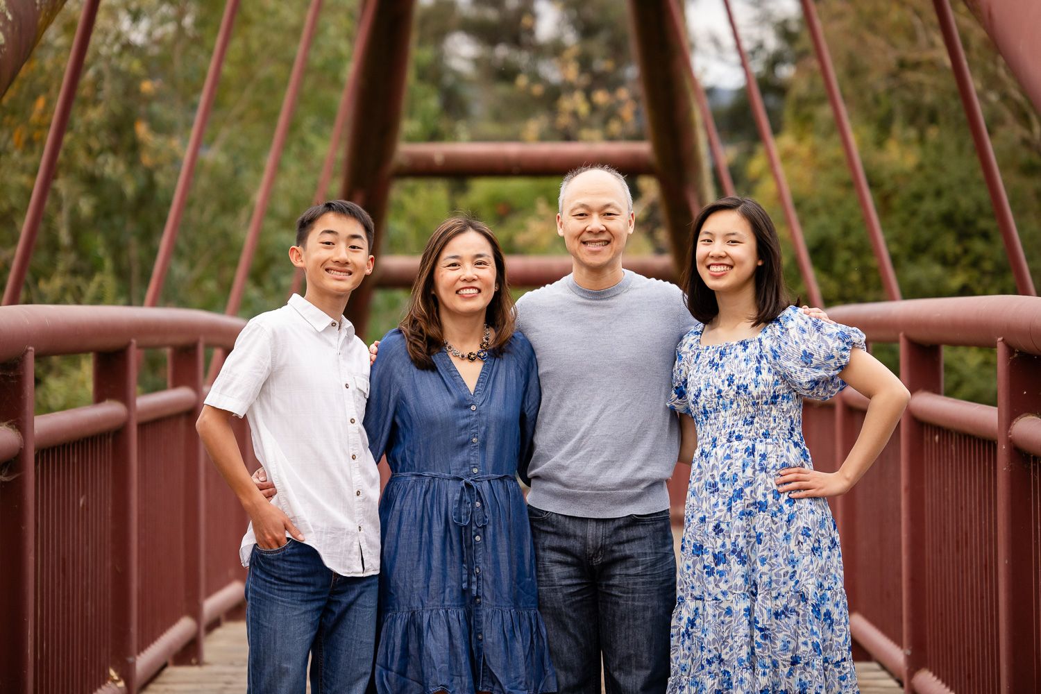 Family poses on a bridge in Vasona for their lifestyle photo session in Los Gatos by Bay Area Photographer Cindy Tucey