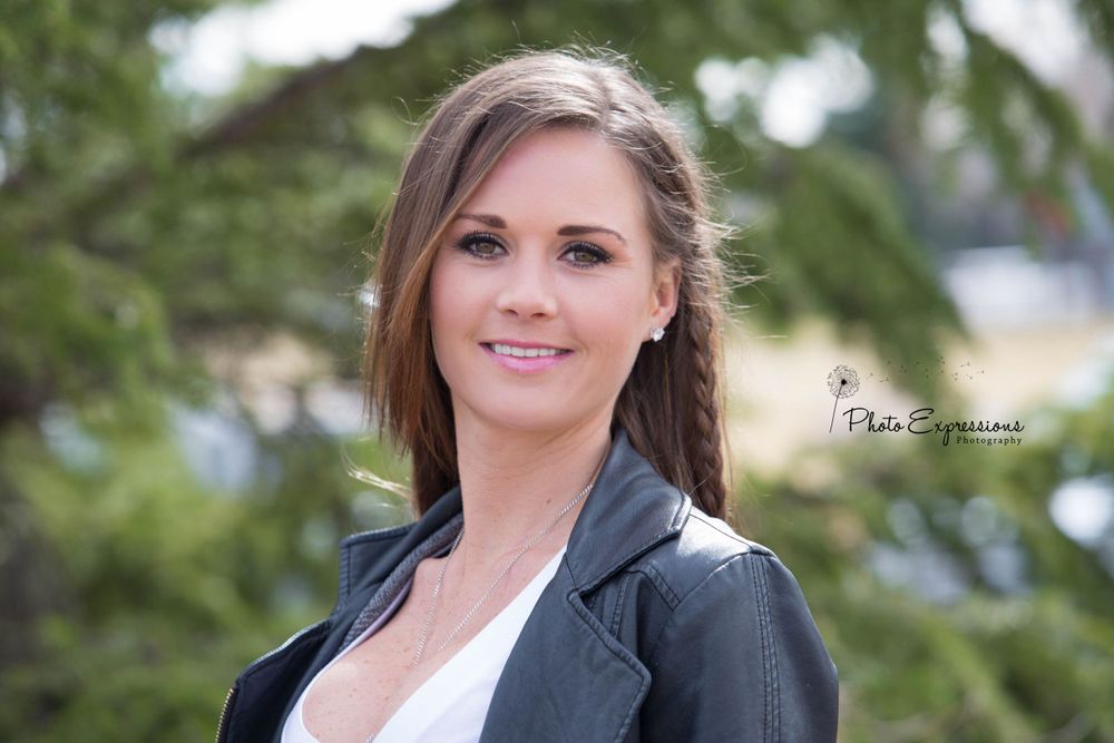 Professional headshot portraits taken outdoors with evergreen trees in the background.