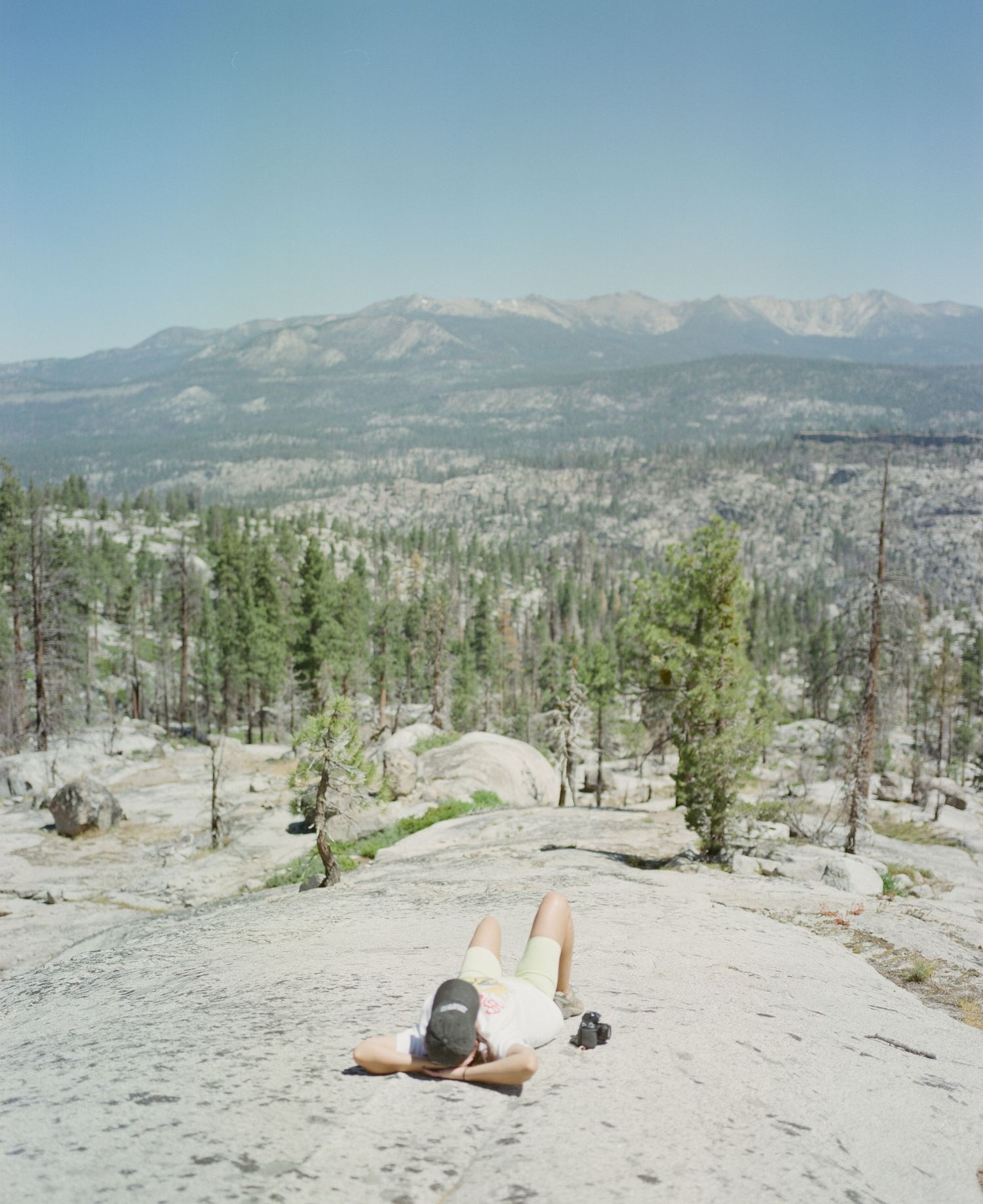 Rocky mountain summit offering expansive views of distant peaks and valleys below.