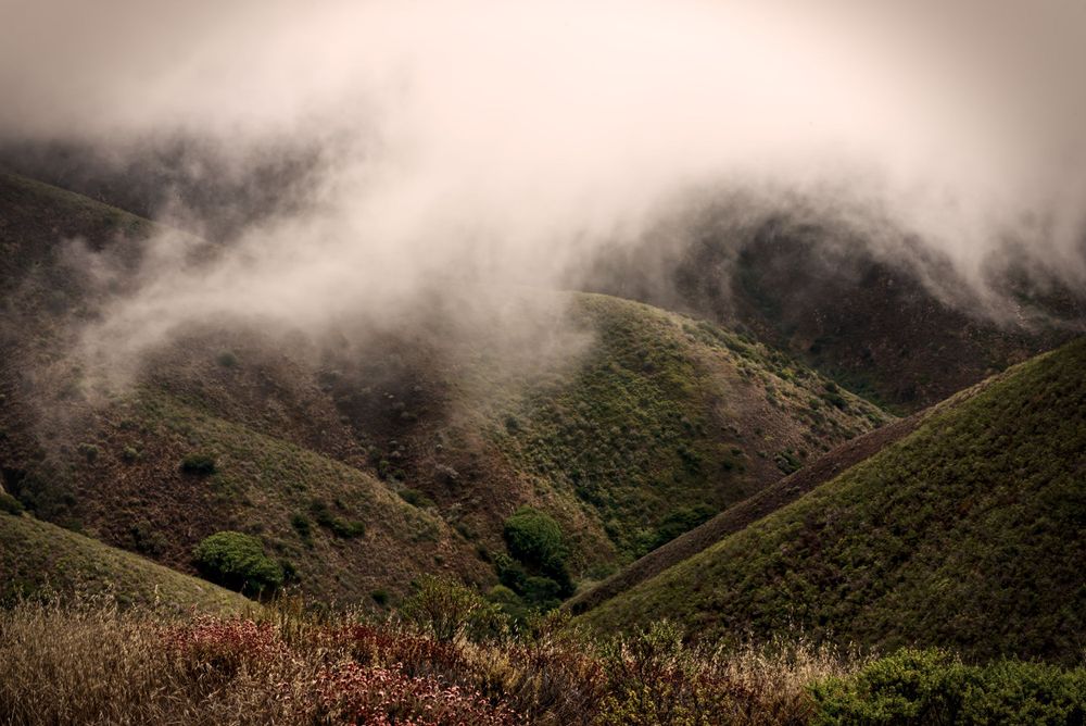Clouds covering the mountain peaks.