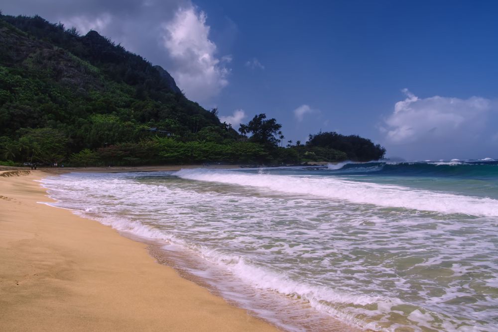 A beautiful beach with soft sand and waves.