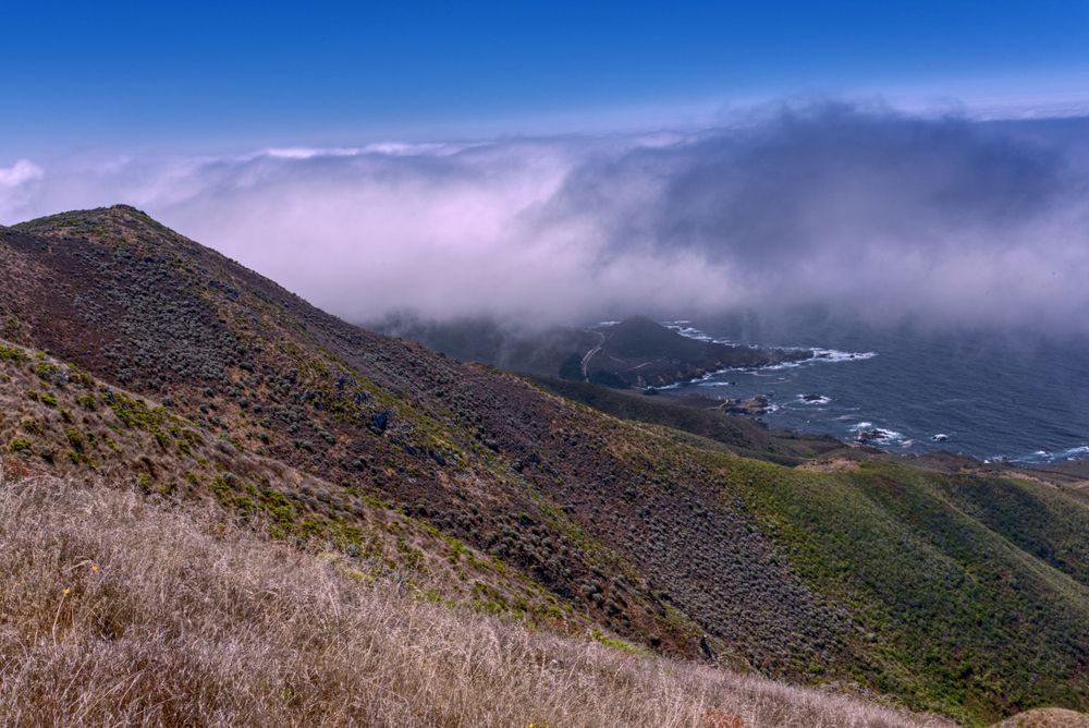 The mountains of Big Sur with clouds and sun.