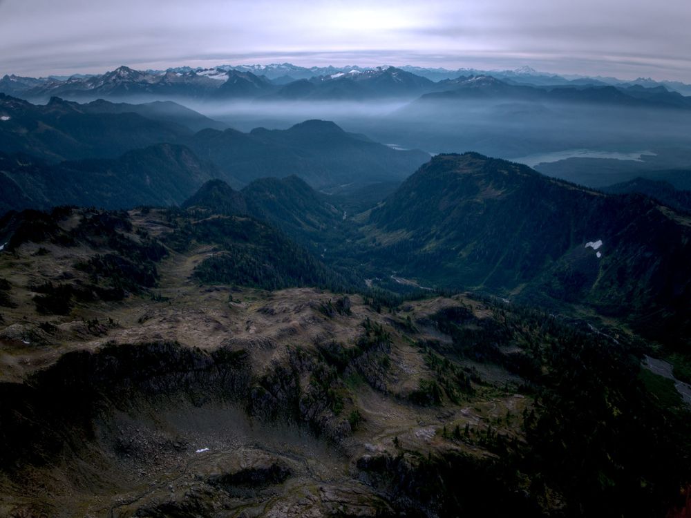 Clouds and smoke over mountain range.