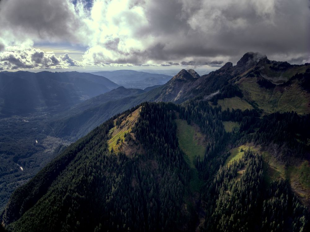 Dramatic clouds with the sun falling on the mountain peaks.