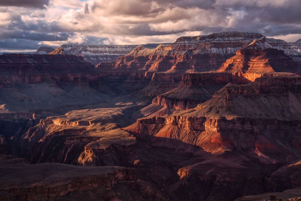 A beautiful sunset with dramatic clouds over the Grand Canyon.