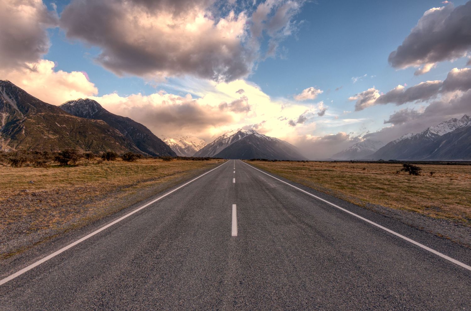 The road to Mt. Cook in New Zealand with dramatic clouds and rain.