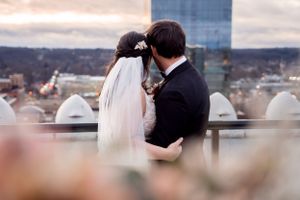 Bride and groom looking out at Grand Rapids, Michigan standing on top of the tower at McKay Ballroom.