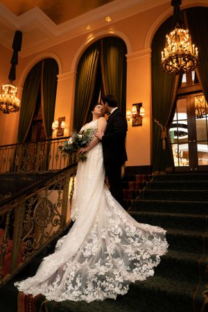 Bride and groom posed on the stairwell in the Amway Grand of Grand Rapids, Michigan.