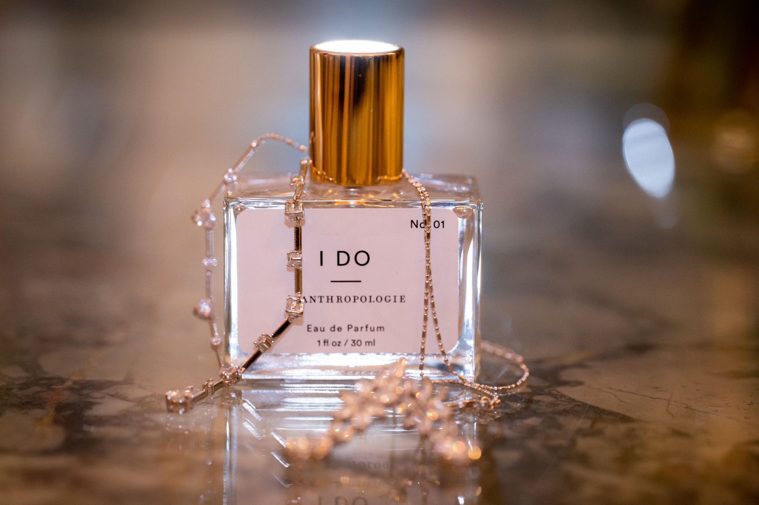 Detail shot of the brides perfume and jewelry.