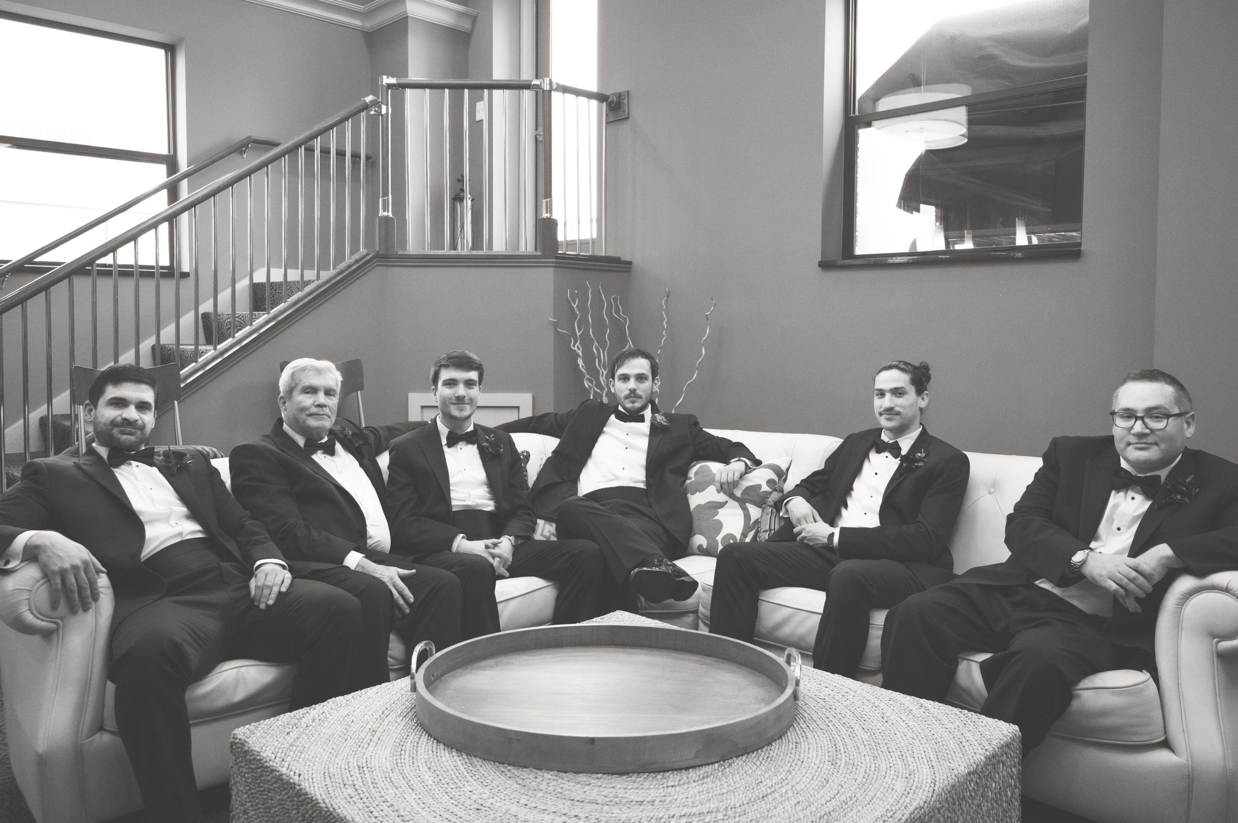 Groom and groomsmen preparing for the ceremony in the grooms quarters in the tower at McKay ballroom in Grand Rapids, Michigan.