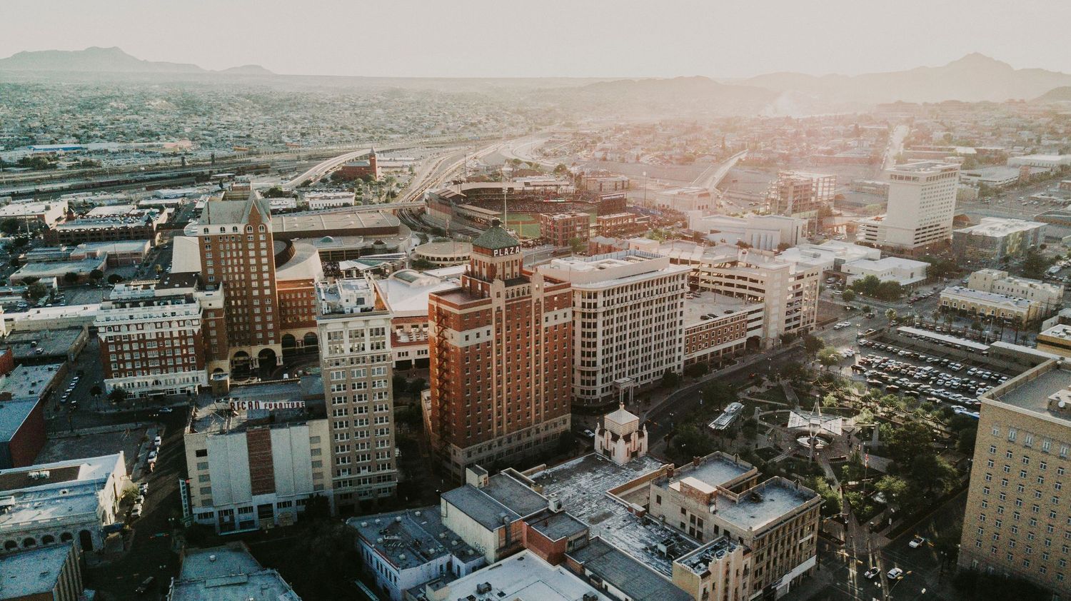 Scenic aerial cityscape view of downtown El Paso Texas with historic buildings during sunset.