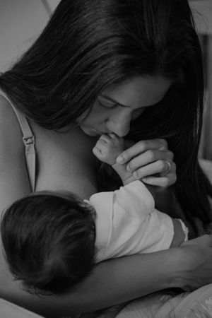 Intimate black and white portrait of maternal bonding moment.