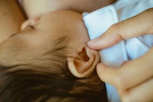 Close-up detail of a baby's ear during a tender moment.