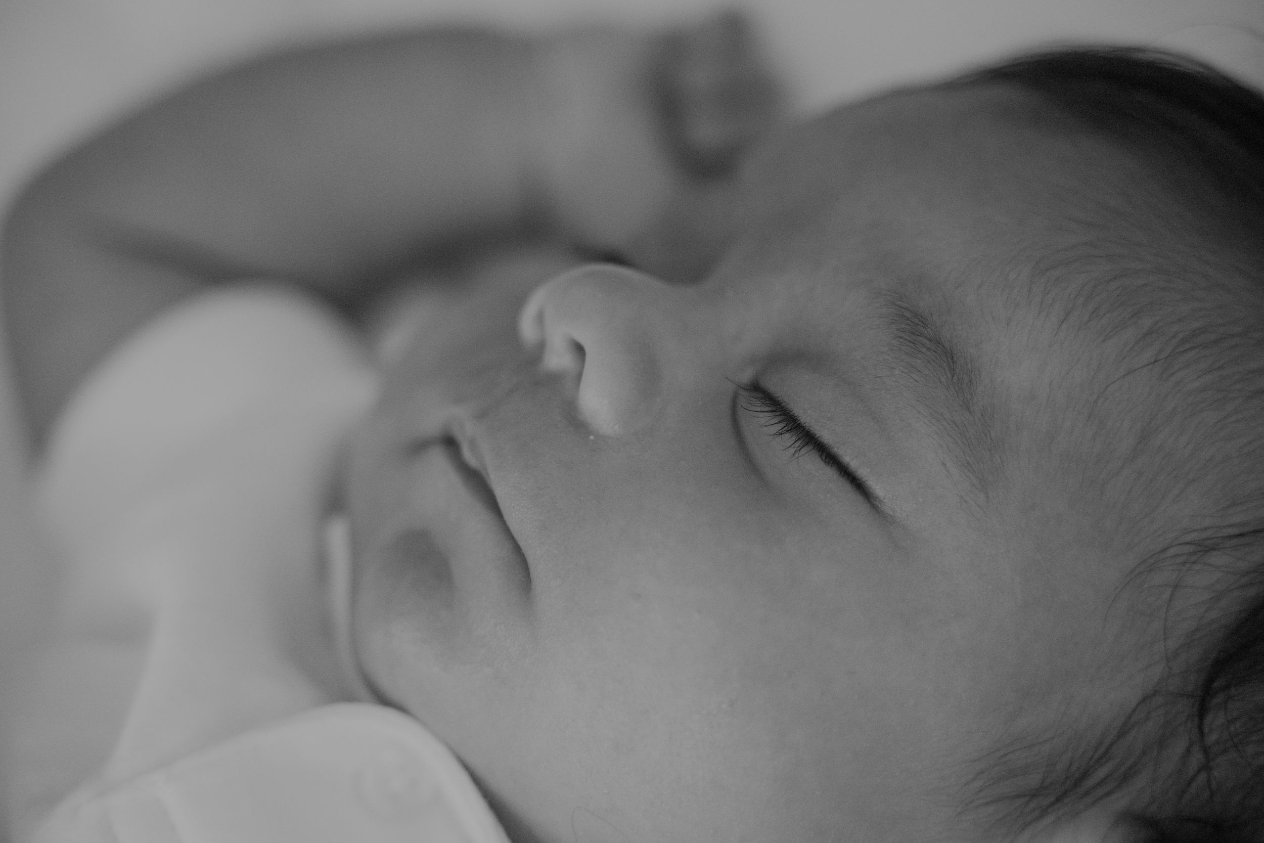 Black and white portrait of sleeping infant.