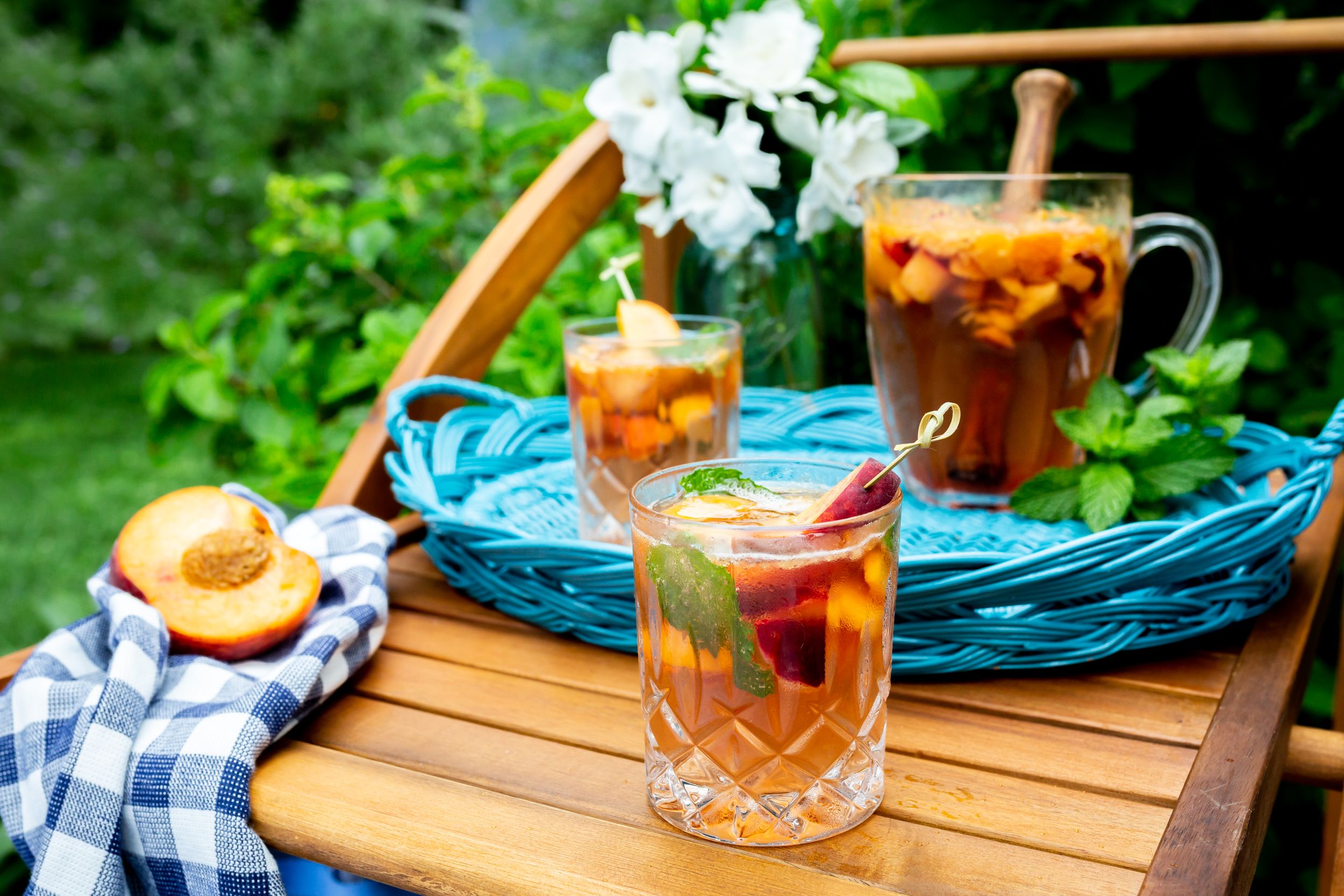 Refreshing iced tea with peach slices and flowers served on wooden table in garden setting.
Commercial Photography
HGTV