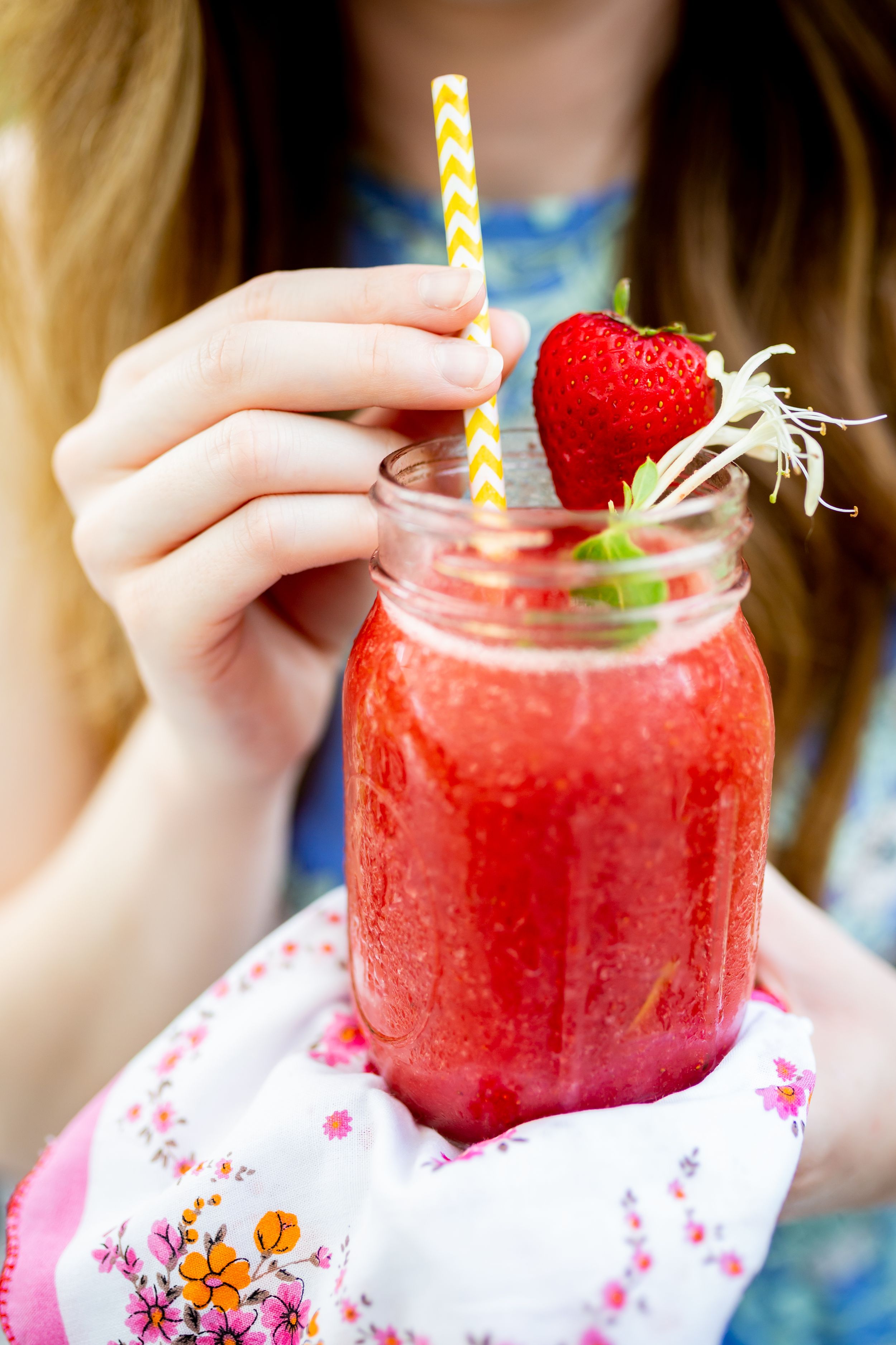 Fresh strawberry smoothie in mason jar with striped straw and fruit garnish.
Commercial Photography
HGTV