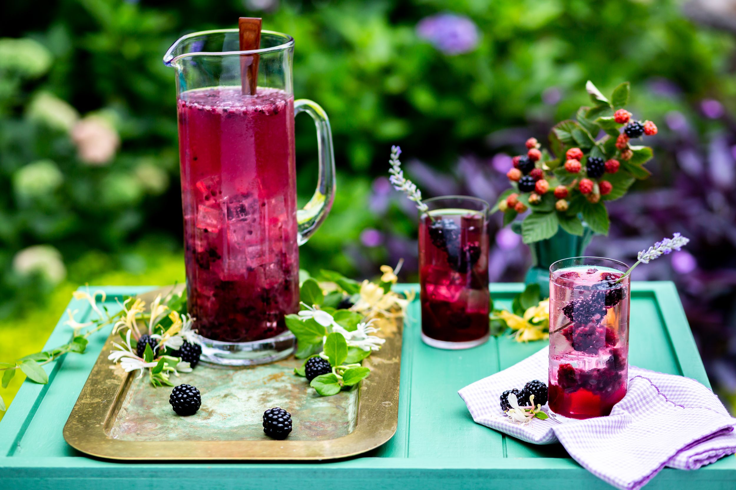 Refreshing berry punch served in glass pitcher with fresh fruits on turquoise outdoor table.
Commercial Photography
HGTV