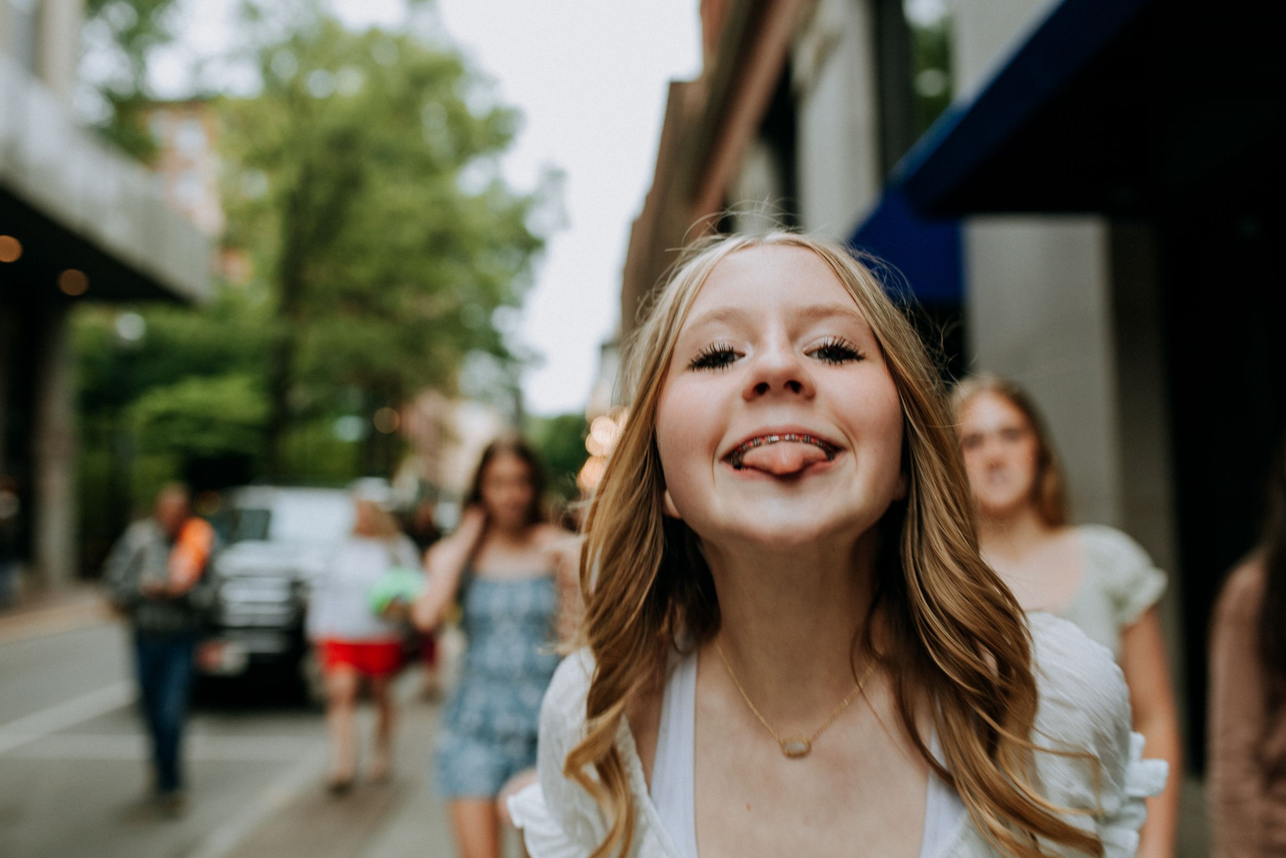 Candid street portrait with natural lighting and urban background.