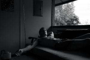 Moody interior shot of a dark room with natural light streaming through windows.