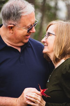 A couple in navy and black clothing share an intimate moment in a series of progressive close-up shots outdoors.