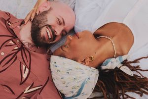 A romantic couple in white floral clothing share intimate moments in a series of photos against a pink background.
