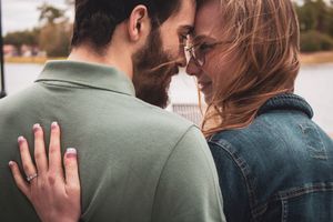A romantic couple embraces and dances together outdoors in a candid photo sequence.