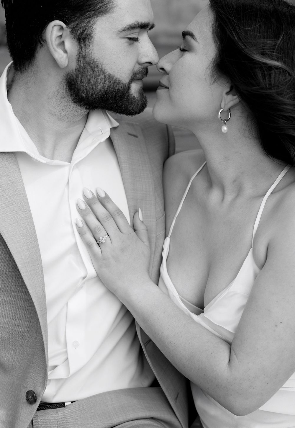 Close-up romantic portrait showing tender moment between couple in formal attire.