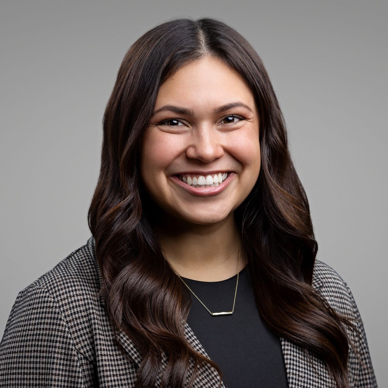 Professional studio portraits against gray background wearing business attire.