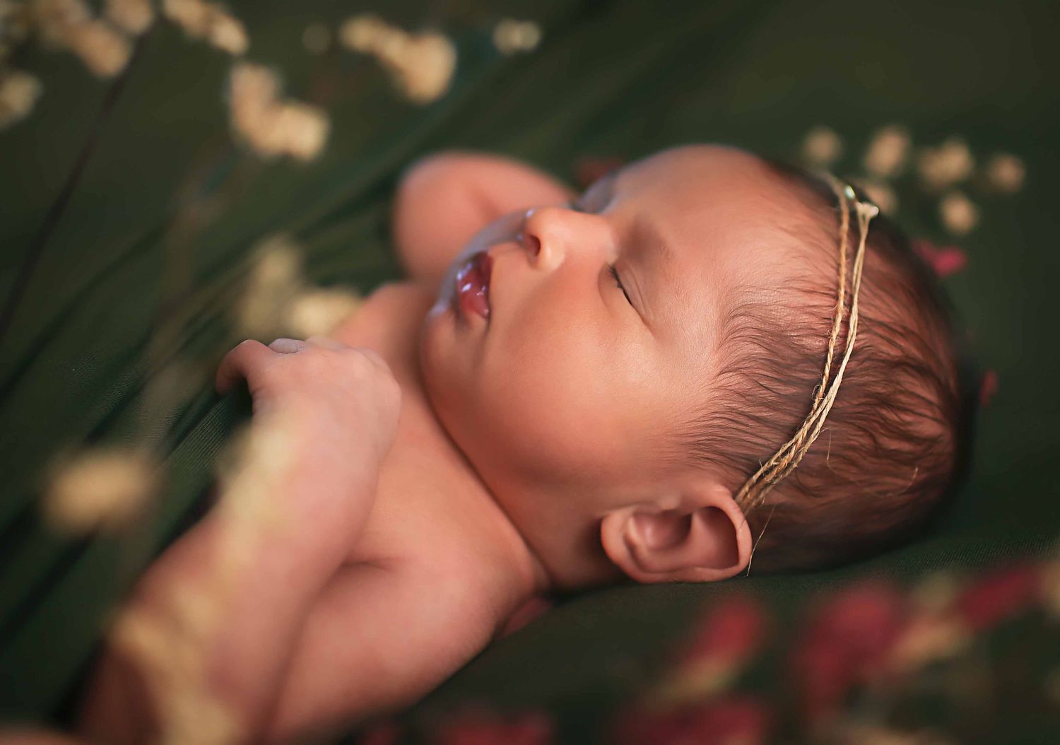 Baby girl sleeping on green fabric for newborn session at Angleton, Tx studio newborn photographer Houston