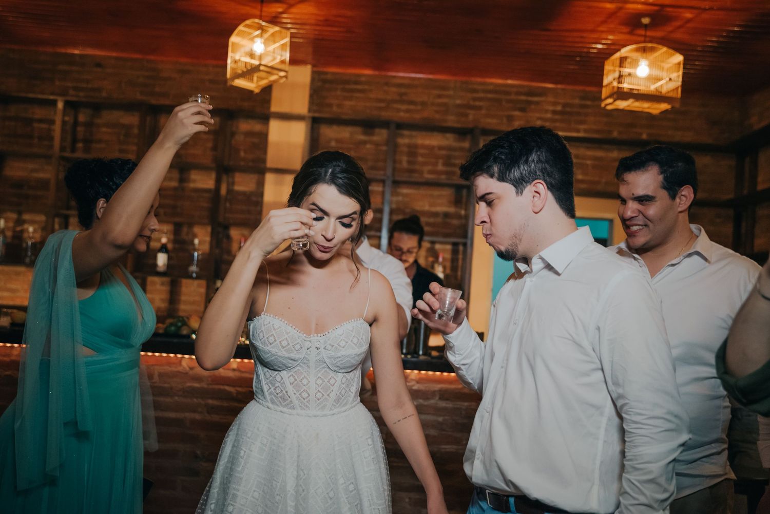 Candid moment between wedding couple during reception in rustic barn venue.