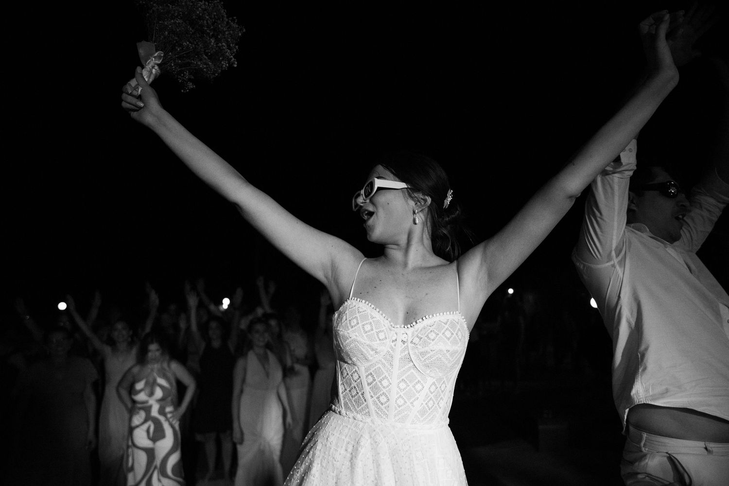 A triumphant pose captured in black and white during a celebratory dance performance.