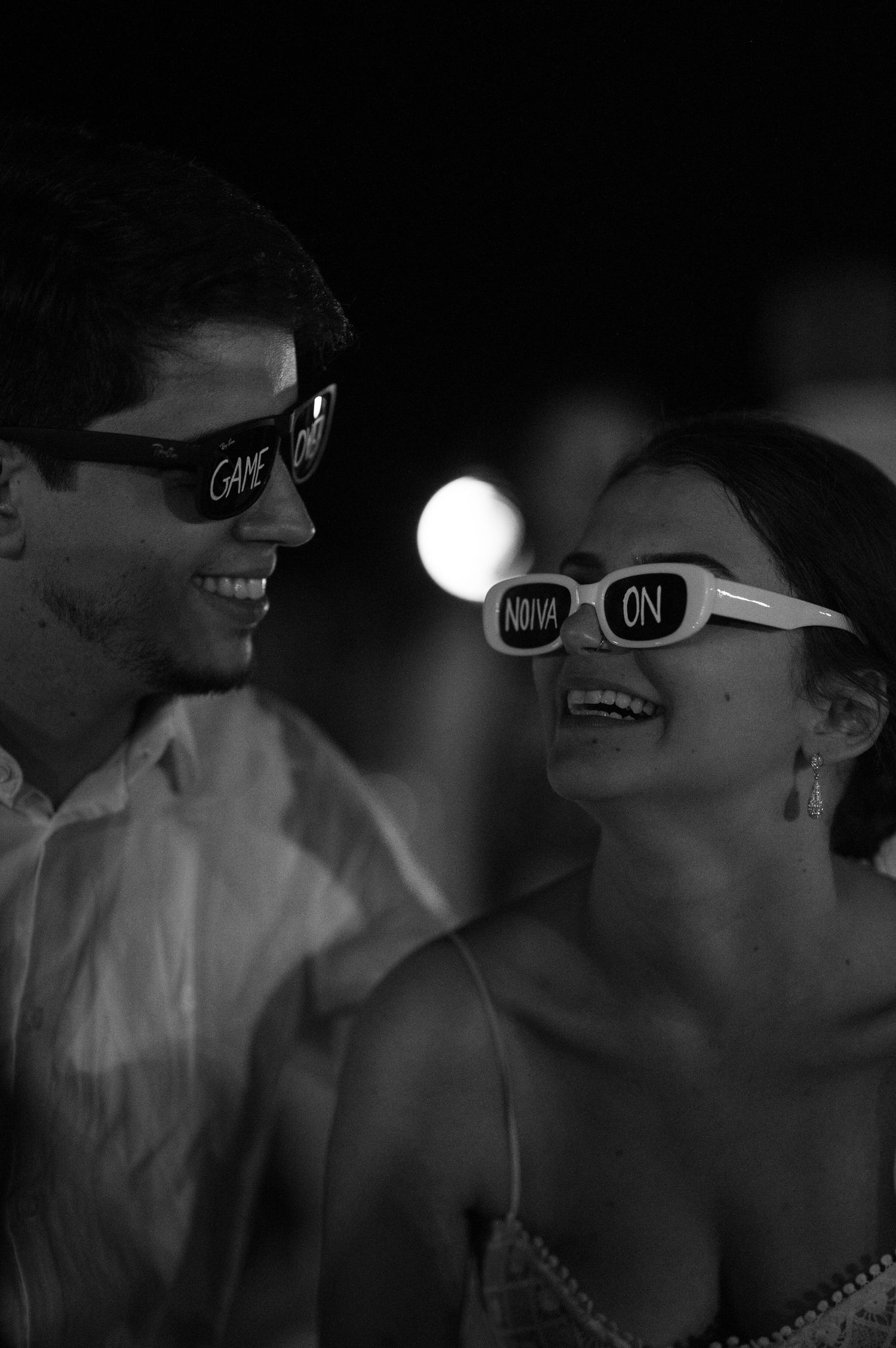 Couple wearing fun novelty sunglasses while dancing at a wedding reception.