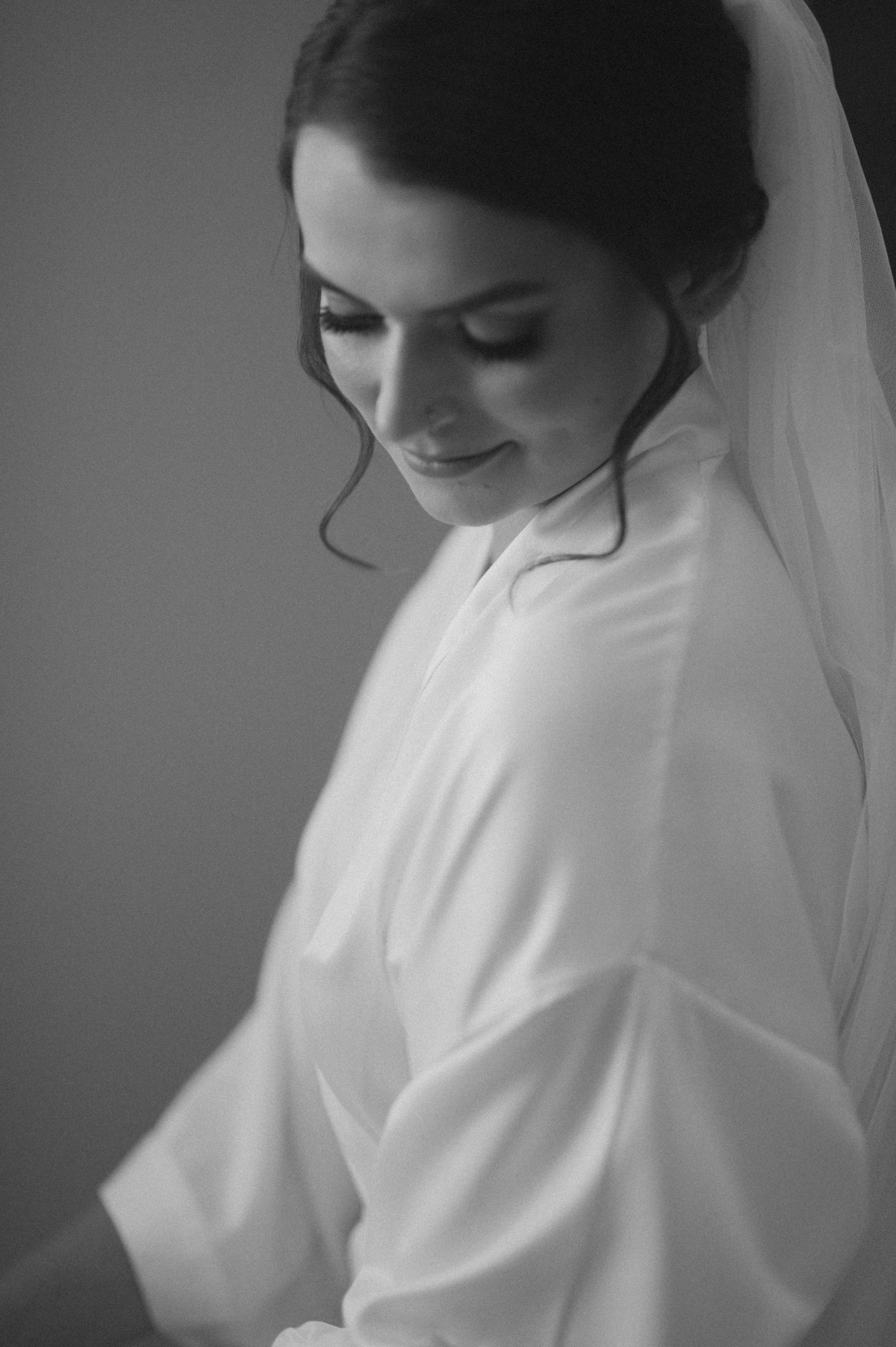 A dreamy black and white bridal portrait showing closed eyes and gentle expression.