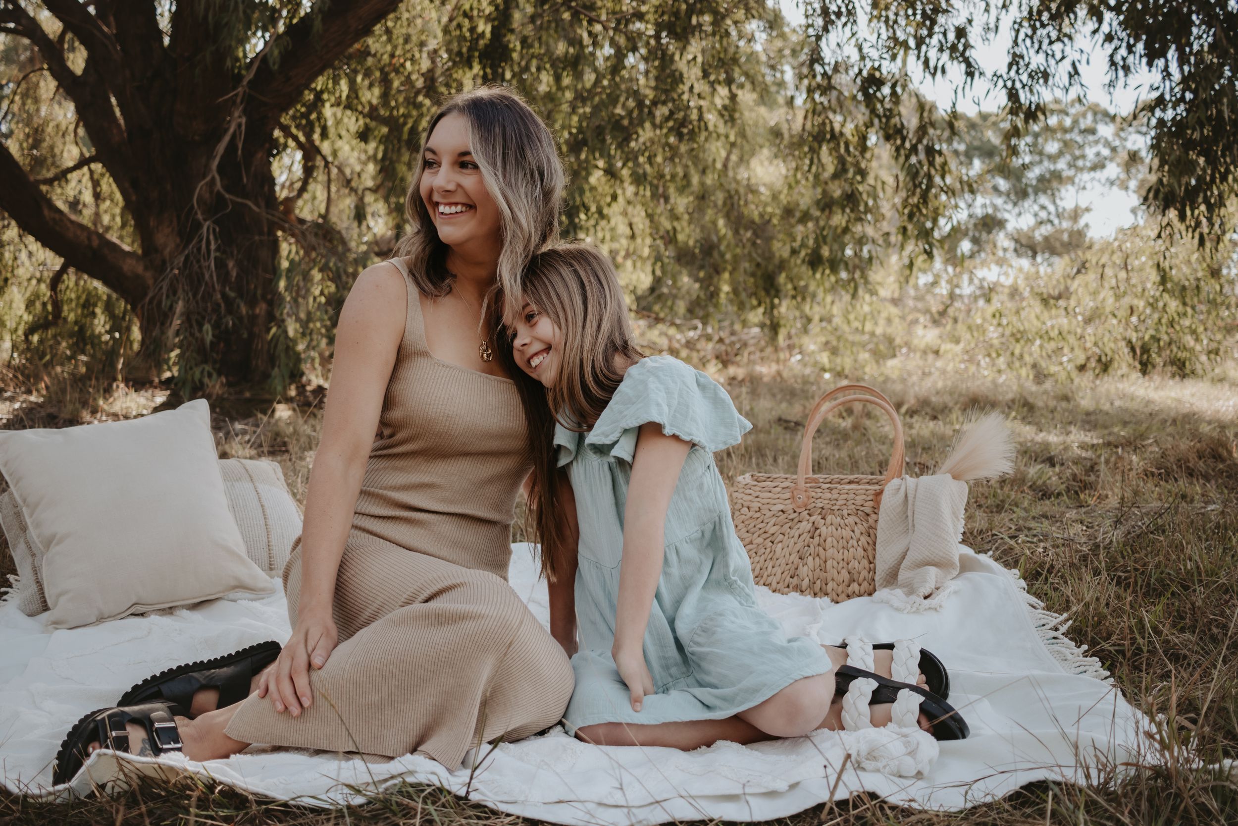Mum and daughter sitting down together.