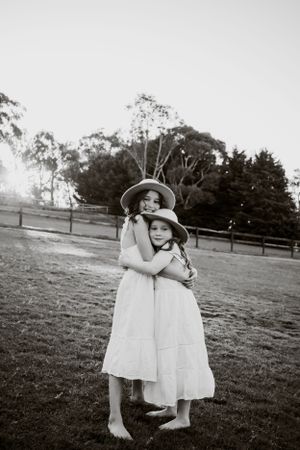 Sister's hugging each other.