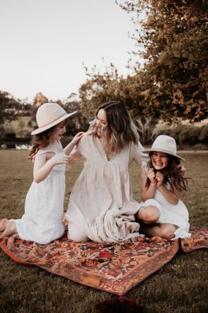 Mum and daughters laughing at each other.