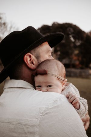 Close up of baby on father's shoulders.