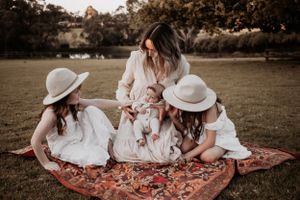 Mum sitting down with her three daughters.