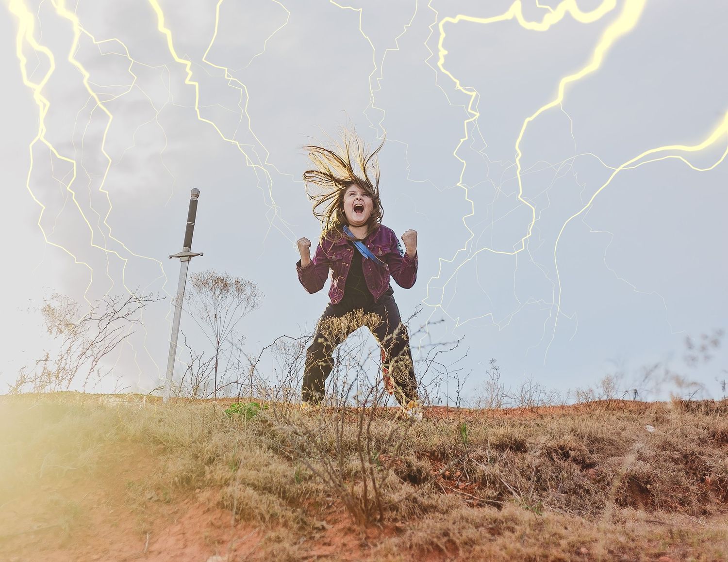 Dramatic photo with added lightning effects showing figure with sword on hilltop.