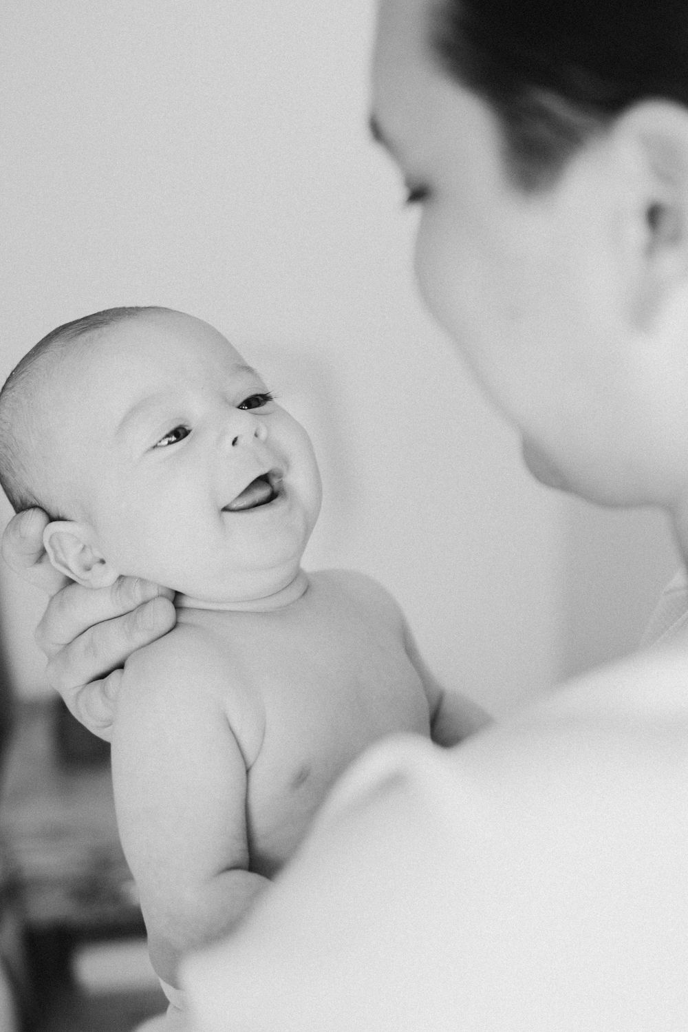 Intimate black and white portrait series showing tender newborn moments.