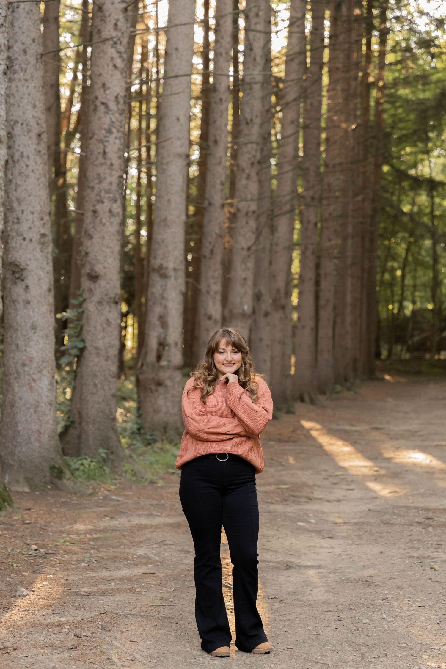 teenage girl posing for a photo at the tree line at the Stoney Creek golf course
