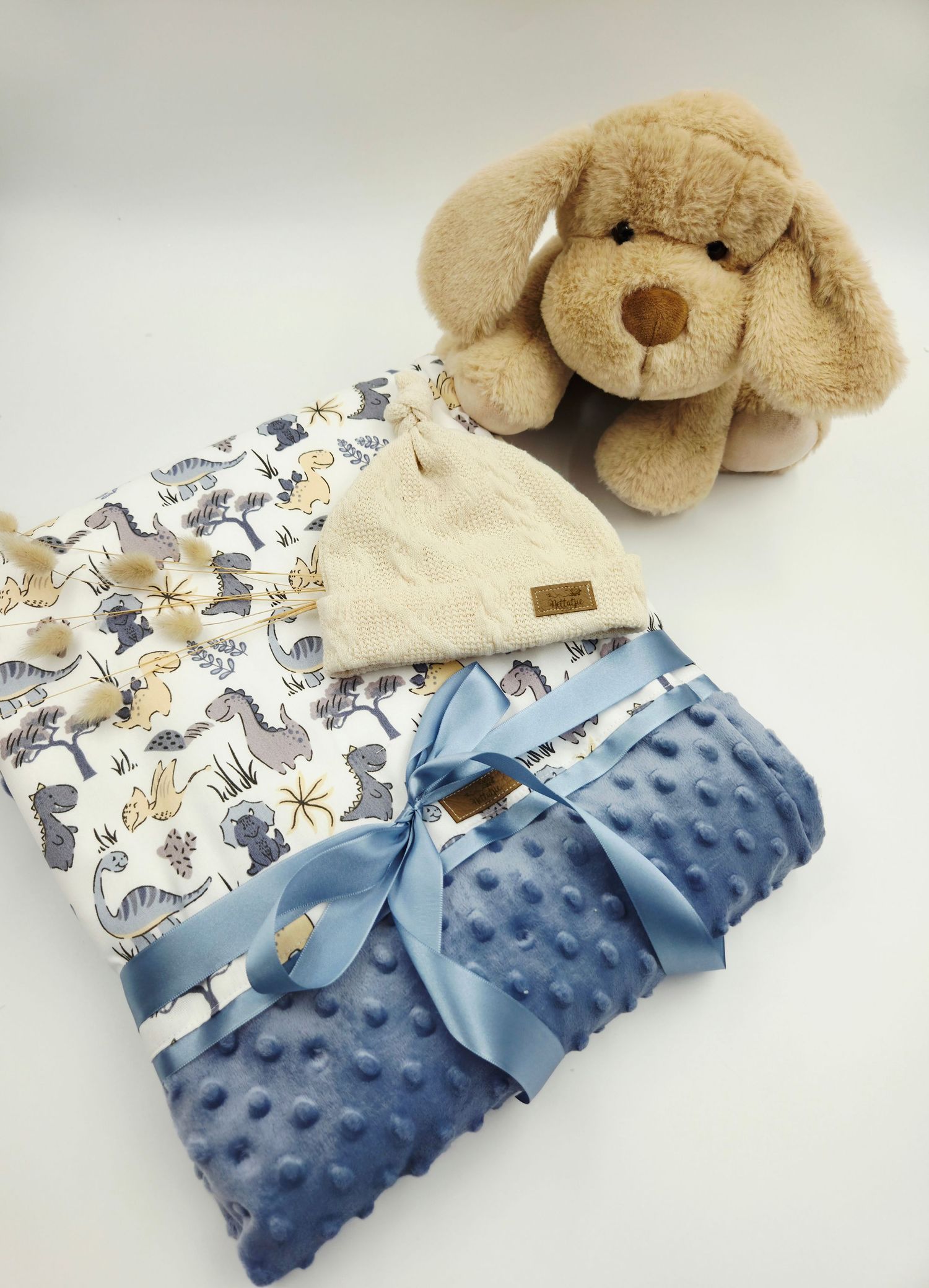 Baby blanket collection featuring blue minky fabric, animal prints, and plush puppy toy.