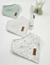 Soft baby bibs and pacifier clip set in sage green gingham, white floral muslin, and waffle knit patterns.