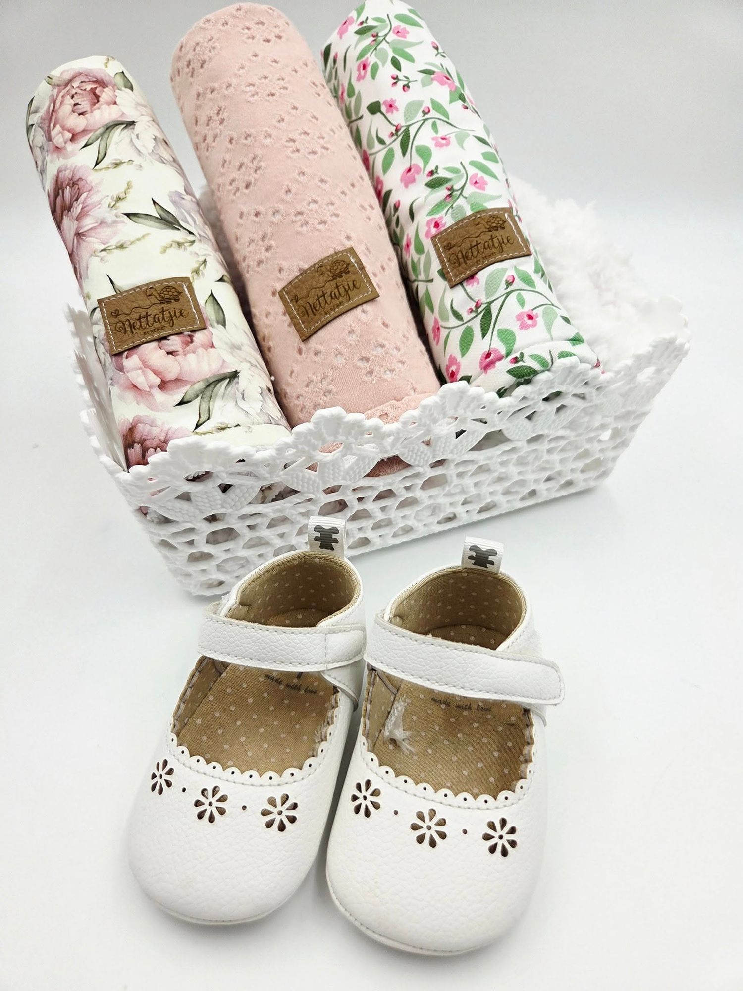 Floral print baby blanket set with pink minky fabric and white Mary Jane shoes.