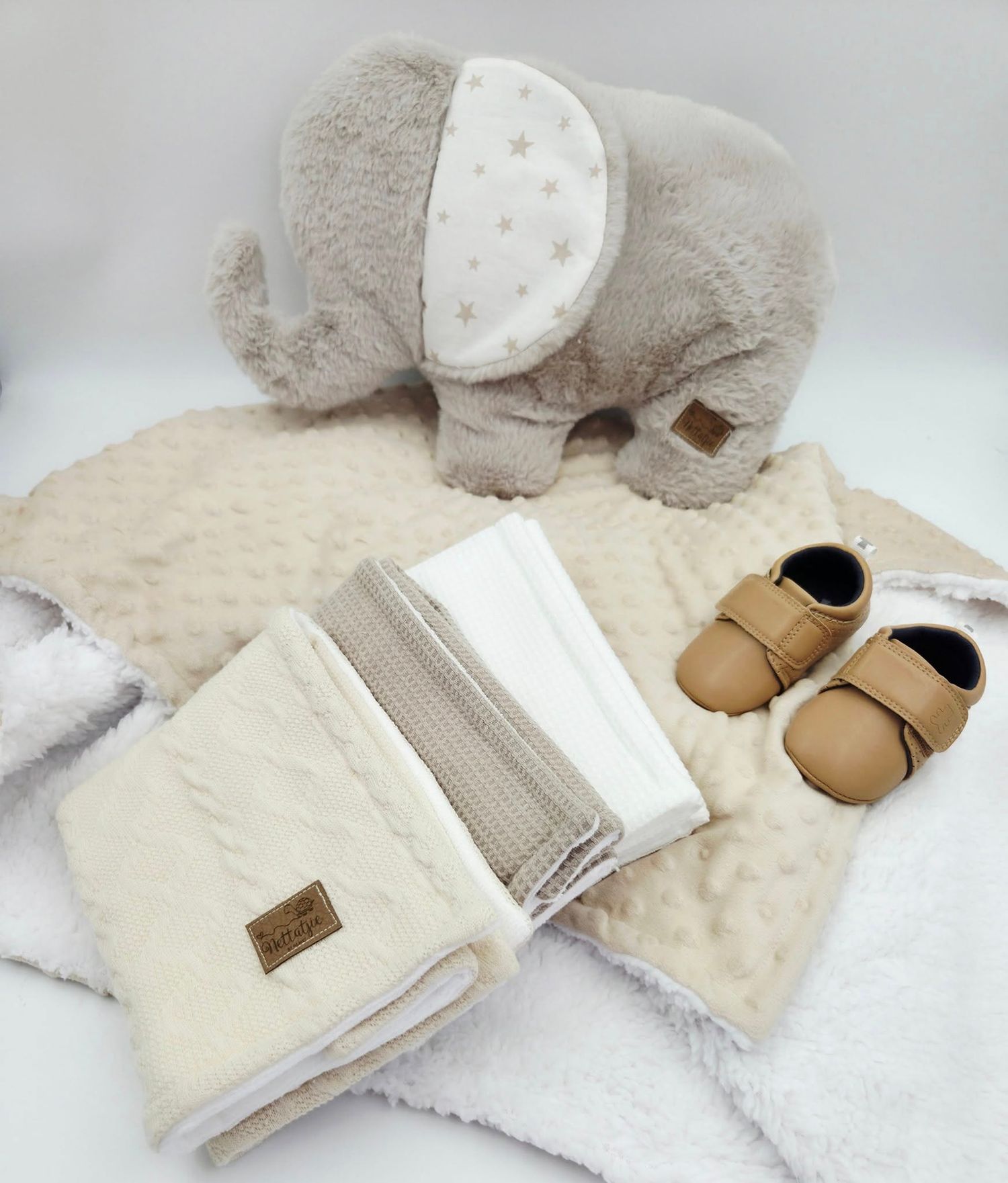 Cream colored minky fabric set with matching accessories and tan baby shoes.